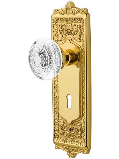 Egg and Dart Door Set with Keyhole and Matching Crystal-Glass Knobs in Polished Brass.